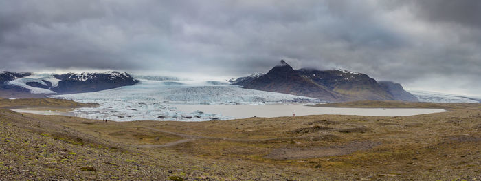 Fjallsarlon glacier slowly empties into a lake calving small icebergs during an icelandic summer