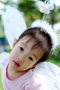 Close-up portrait of girl wearing angel costume