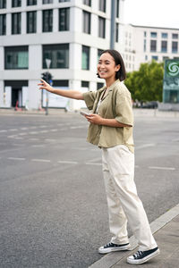 Portrait of young woman standing on road