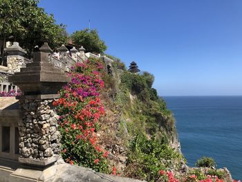 Scenic view of sea by building against clear sky