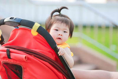 Portrait of cute girl sitting outdoors