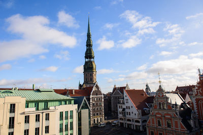 Clock tower in city against sky