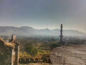 View of cross on mountain against sky