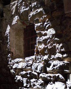 Low angle view of frozen wall by building