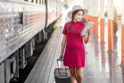 Portrait of young woman using mobile phone