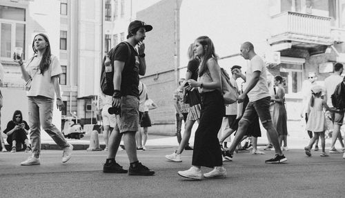 Group of people walking on street in city