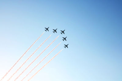 Low angle view of airplane flying against clear sky