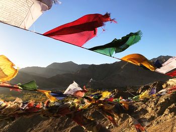 Low angle view of flags against mountain