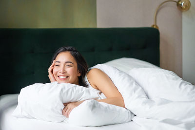 Young woman sleeping on bed at home