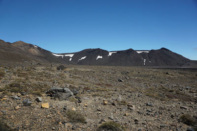 Scenic view of rocky mountains against clear blue sky