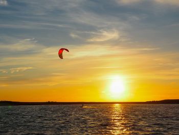 Kite surfing in the ocean at sunset