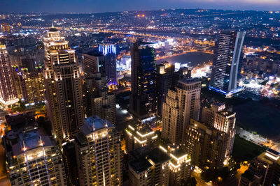 High angle view of city lit up at night