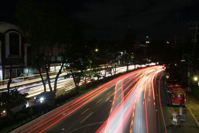 High angle view of light trails on road at night