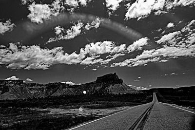 Empty road leading towards mountains