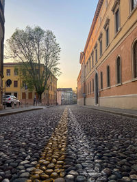 Surface level of cobblestone street amidst buildings in city