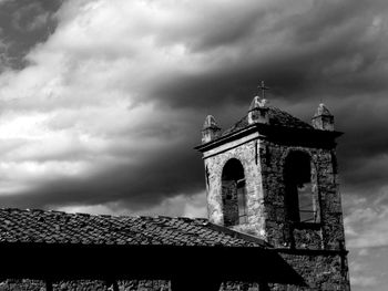 Low angle view of bell tower against sky