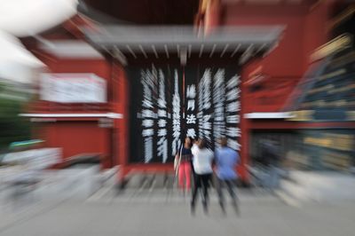 Blurred motion of people walking in building