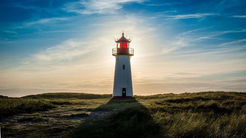 Lighthouse against sky at sunset