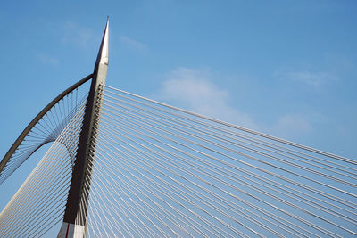 Low angle view of suspension bridge against sky