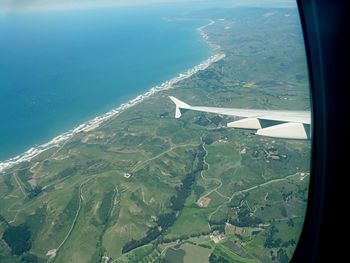 Cropped image of airplane wing over landscape