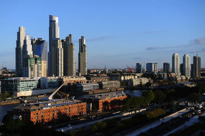 Modern buildings in city against clear sky