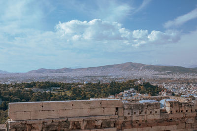 View of townscape against cloudy sky