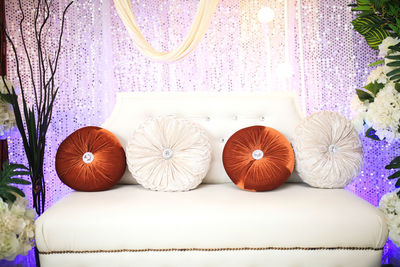 Close-up of christmas decorations on sofa at home