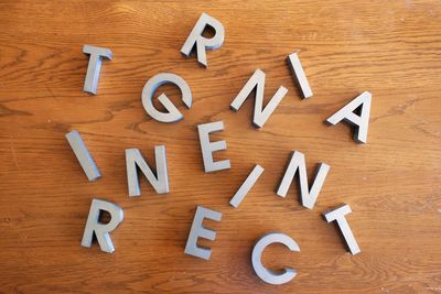 High angle view of letters on wooden table