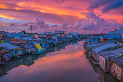 High angle view of illuminated buildings against sky at sunset