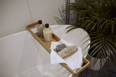 Cosmetics on shelf over bathtub