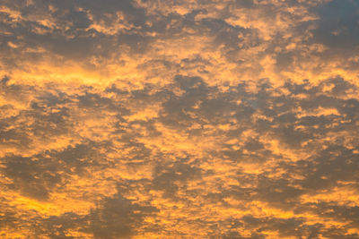 Low angle view of cloudy sky at sunset