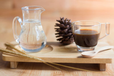 Close-up of black tea and pine cone on table