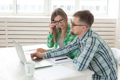 Man and woman using mobile phone