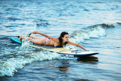 Young woman in boat at sea shore