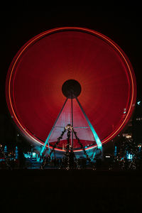 Illuminated ferris wheel at night