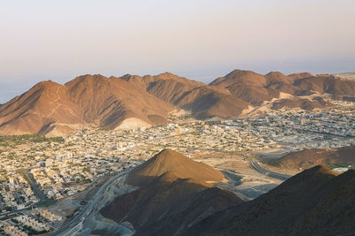 Scenic view of desert mountains against sky in khorfakan uae. 