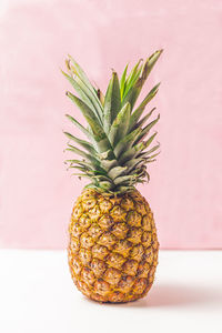 Close-up of fruit on table against wall