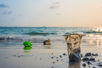 Close-up of rocks on beach against sky