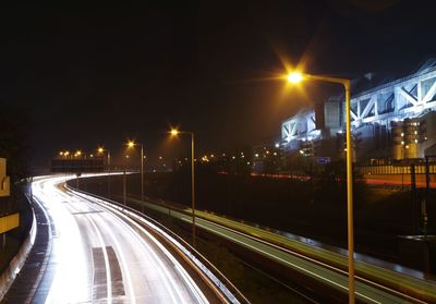 Light trails on road in city at night