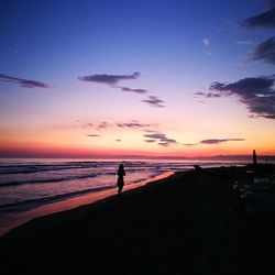 Scenic view of beach against sky during sunset
