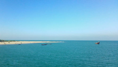 Scenic view of sea and shore against clear sky