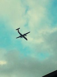 Low angle view of airplane flying in sky