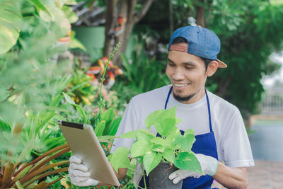 Portrait of young man using mobile phone outdoors