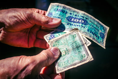 Cropped hand holding paper currency
