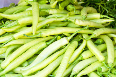 Full frame shot of green chili peppers for sale in market