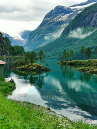 Scenic view of lake and mountains against sky