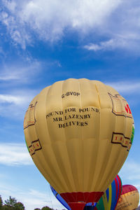 Low angle view of hot air balloon against blue sky