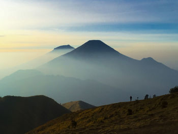 Scenic view of mountains against cloudy sky