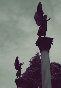 Low angle view of statue against sky