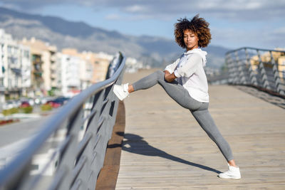 Young woman exercising on street